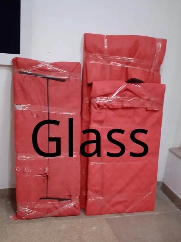 Glass panels wrapped in quilted padding for house shifting in Gurgaon